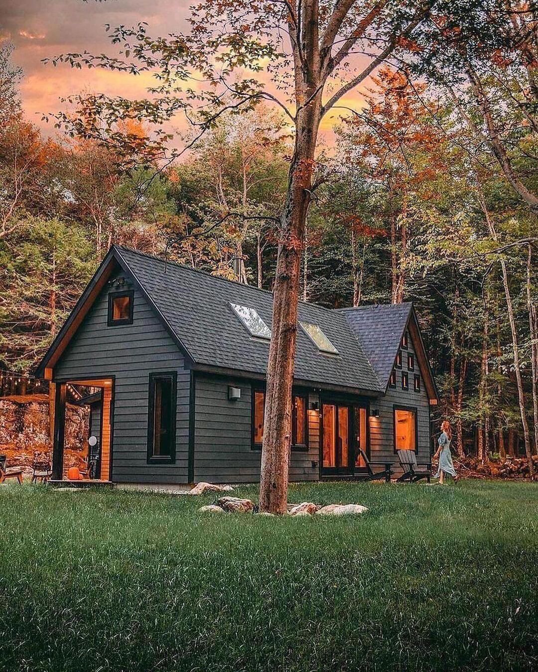 A cozy A-frame cabin nestled among autumnal trees