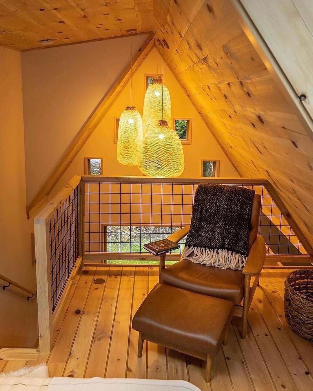 A cozy reading nook under a sloped wooden ceiling