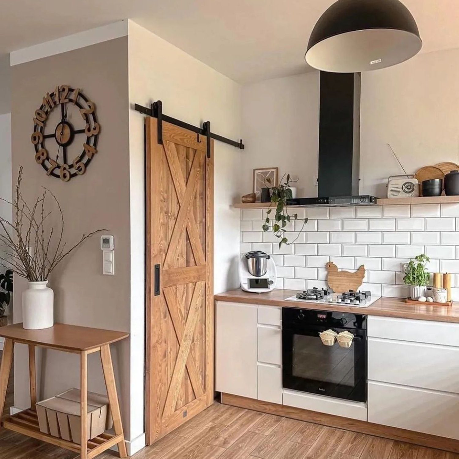 A modern kitchen with a rustic touch featuring a sliding barn door