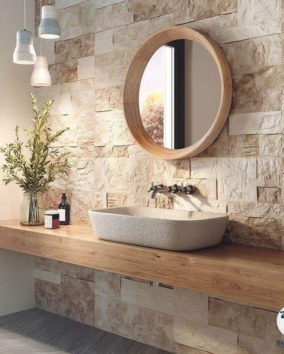 Modern bathroom with rustic elements featuring a stone accent wall