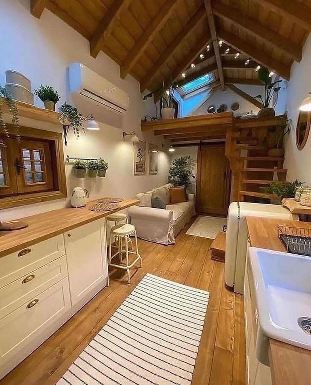 A cozy attic apartment kitchen with skylights and wooden details