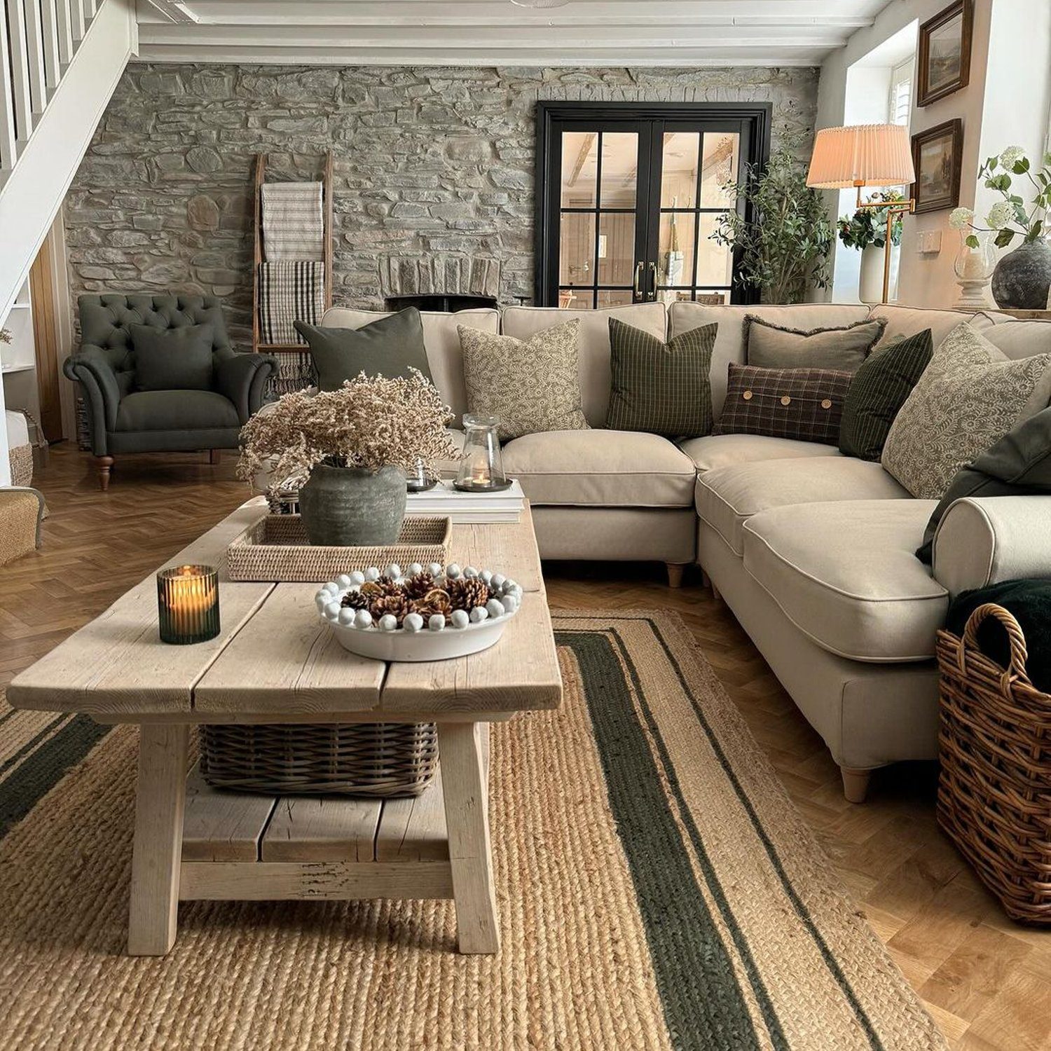 A cozy and inviting living room with stone accent walls and a mix of textures