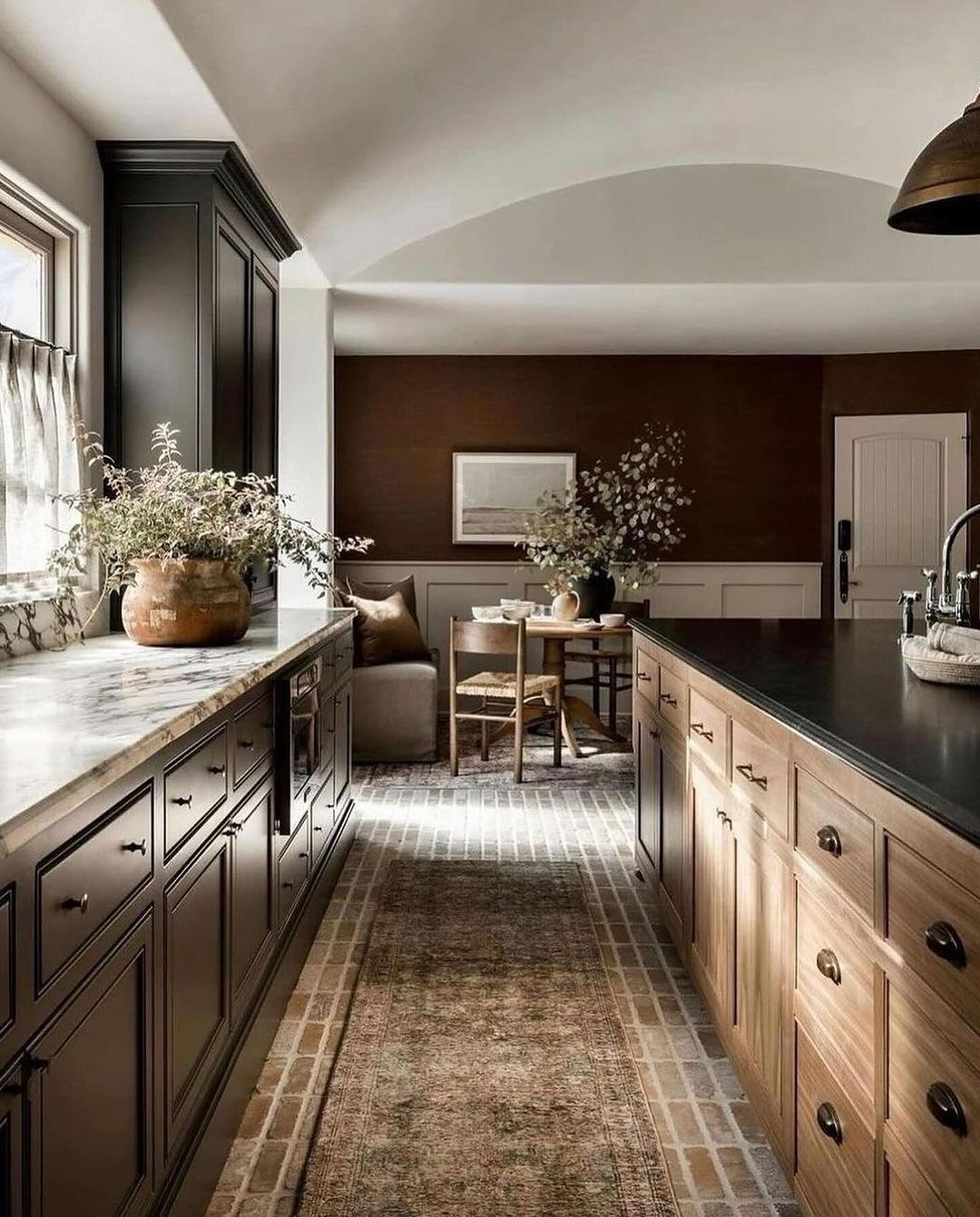 A tastefully designed kitchen with a balance of wood and dark-colored cabinetry