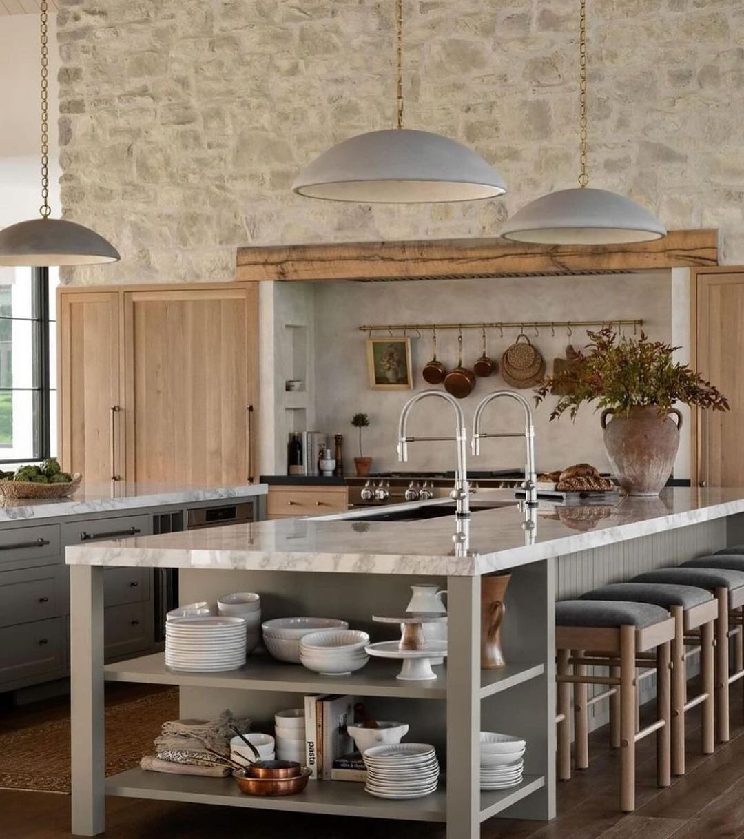 A modern kitchen seamlessly blends rustic charm with contemporary elegance, featuring a stone wall backdrop, natural wood cabinetry, and sleek countertops