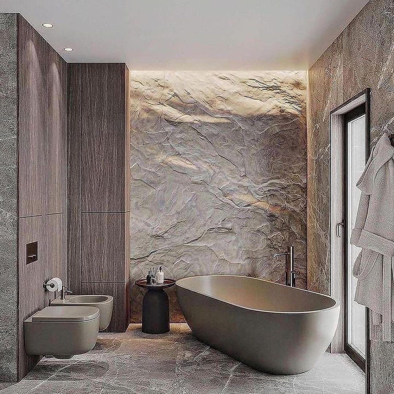 A modern bathroom with textured stone walls and a freestanding bathtub