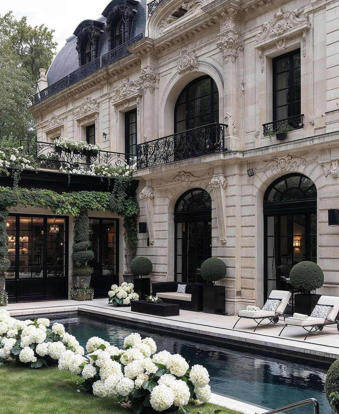 Classic French architecture with a serene garden and pool area