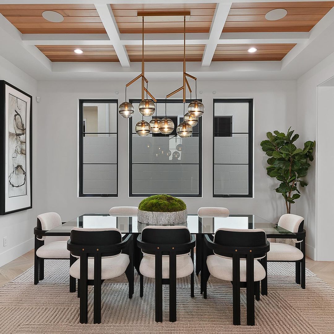 A chic modern dining room with a coffered ceiling