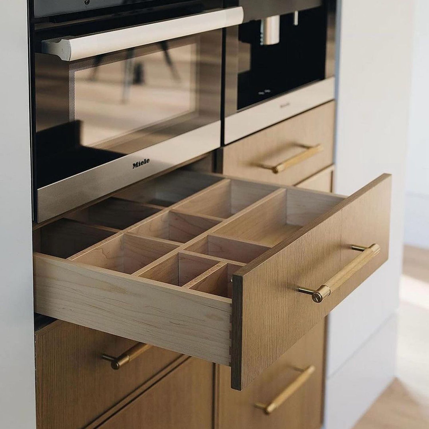 A modern kitchen drawer with elegant organization compartments