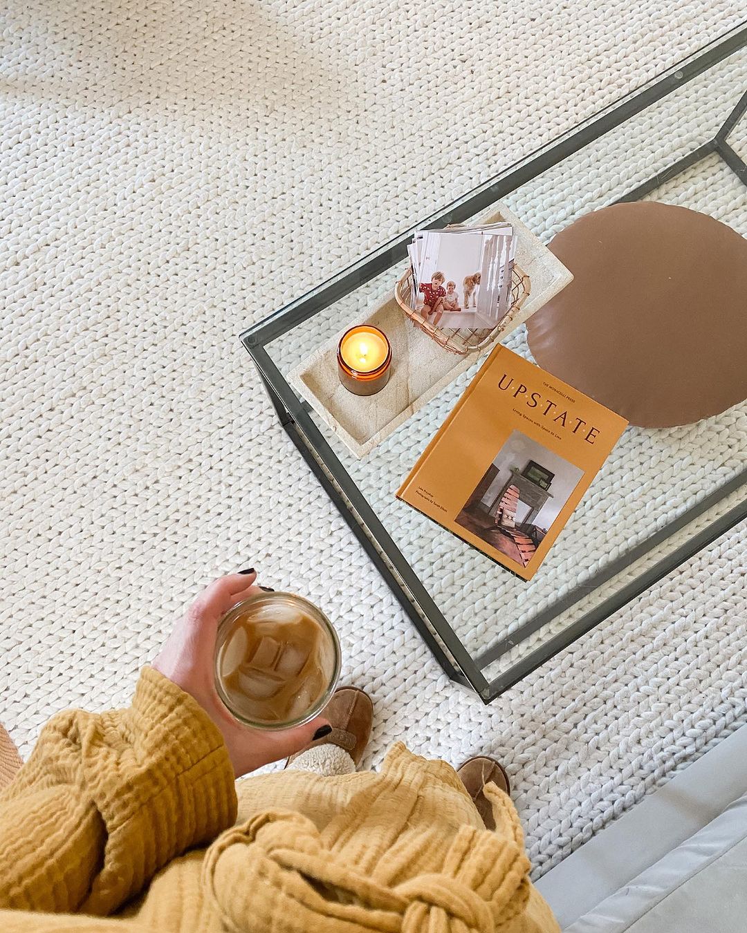 Cozy home setting with a person holding a glass