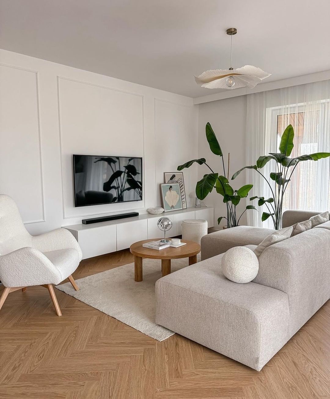 A serene and modern living room design featuring a beige upholstered sofa