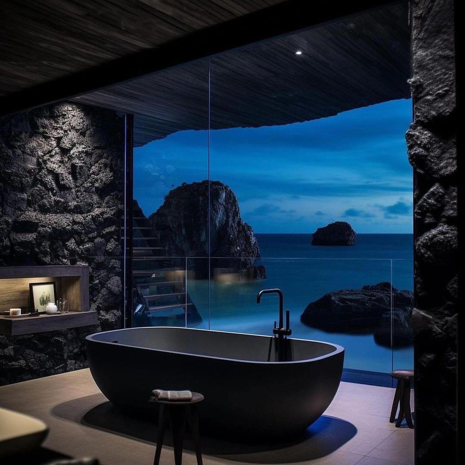 A luxurious bathroom with twilight ocean view