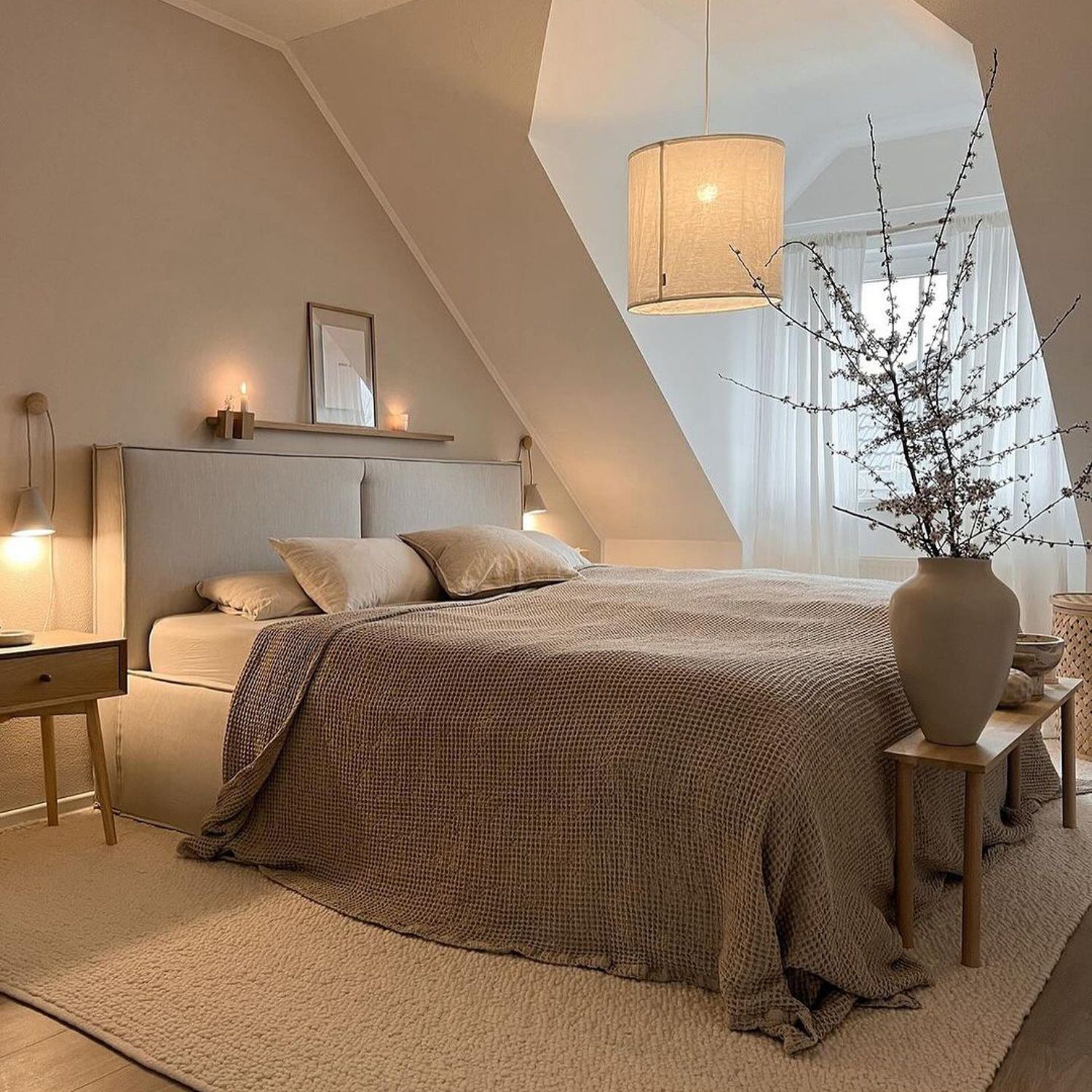 A cozy and minimalist bedroom with sloped ceilings