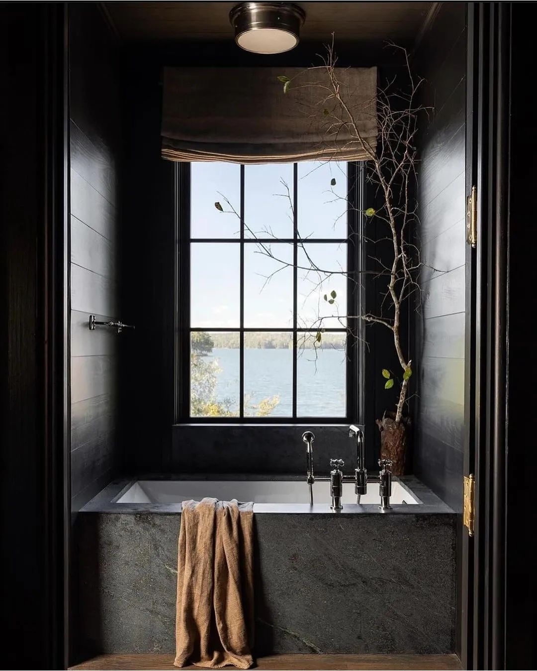 A tranquil bathroom with a picturesque window view of the lake