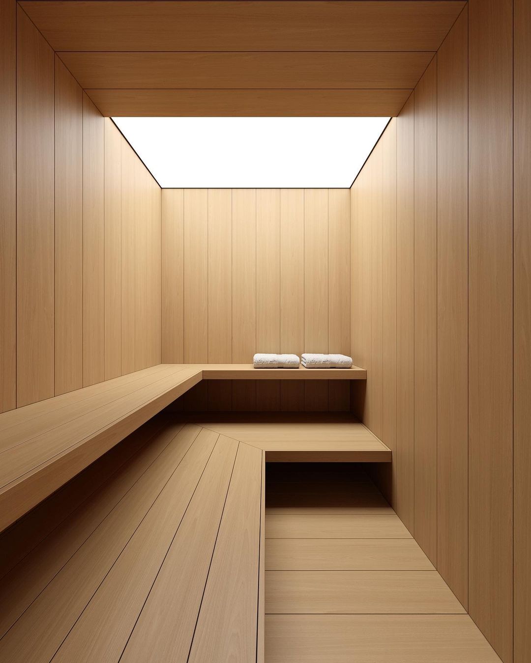 A serene wooden sauna room with a skylight