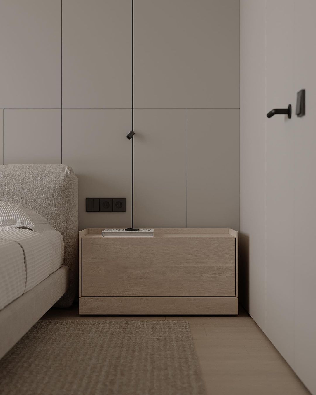 A minimalist bedroom corner with sleek built-in cabinets and a modern aesthetic