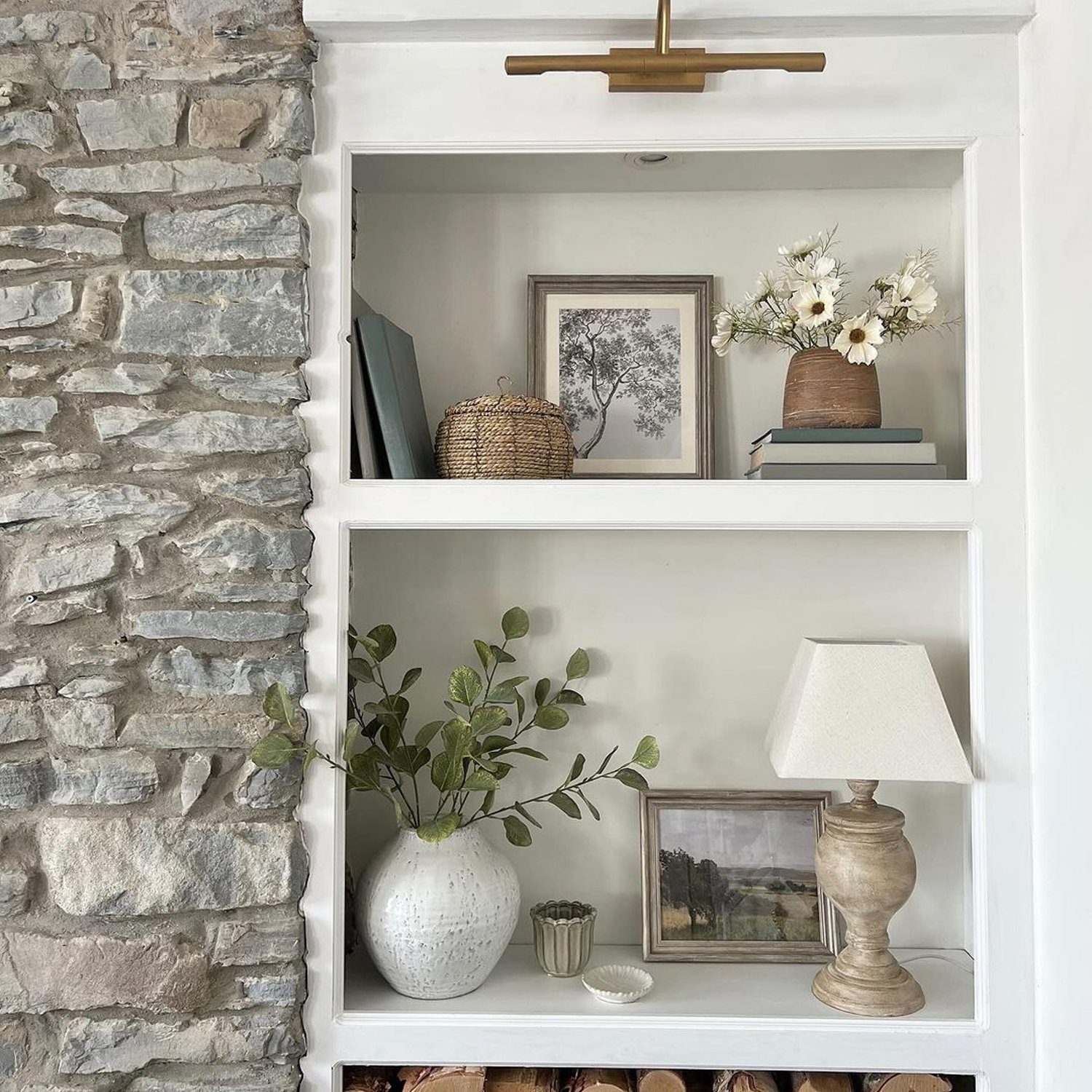 Cozy alcove with stone wall and decorative shelves