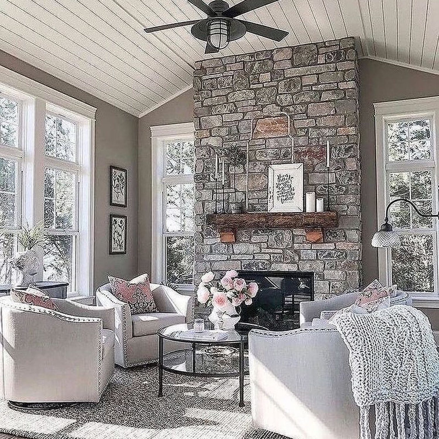 Cozy living room featuring a stone fireplace and elegant decor