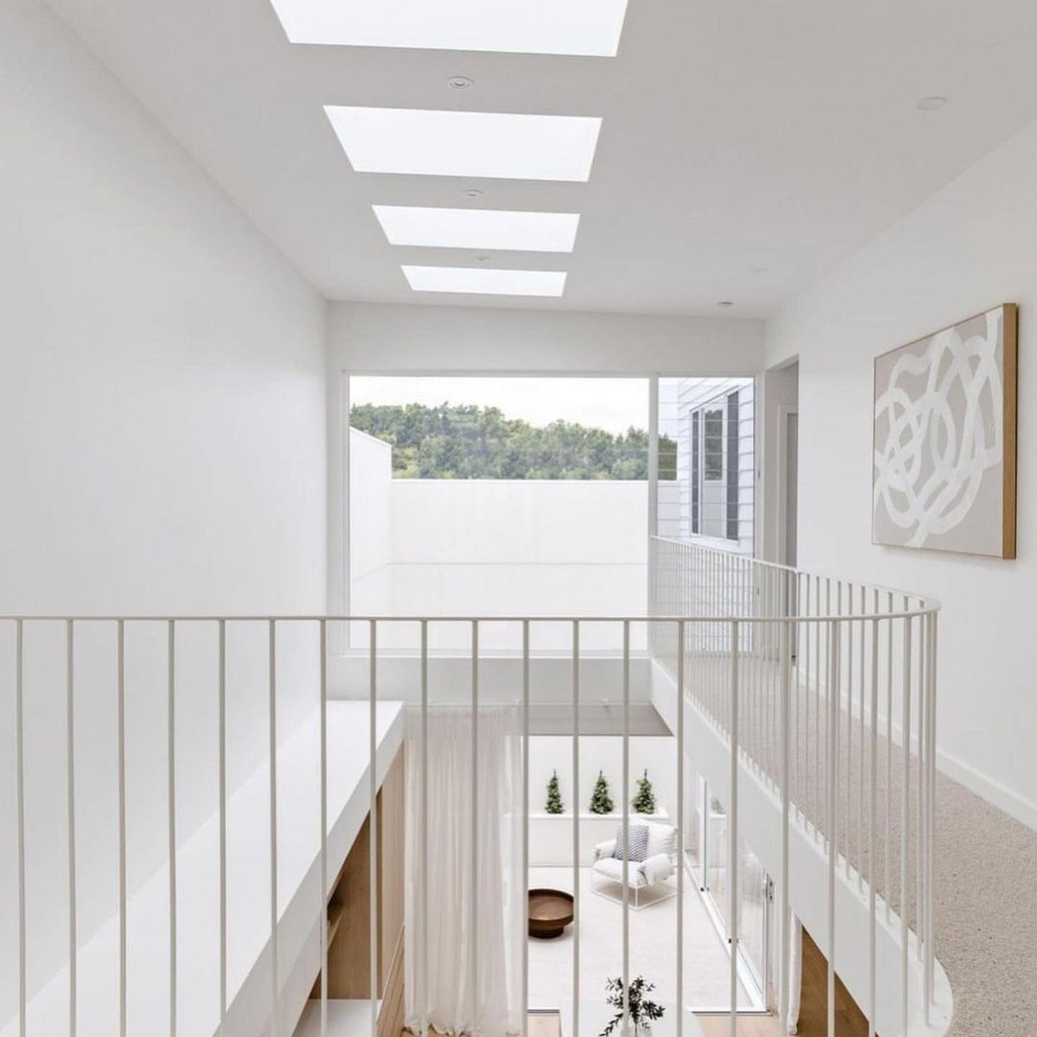 A modern and airy double-height living area with skylight panels