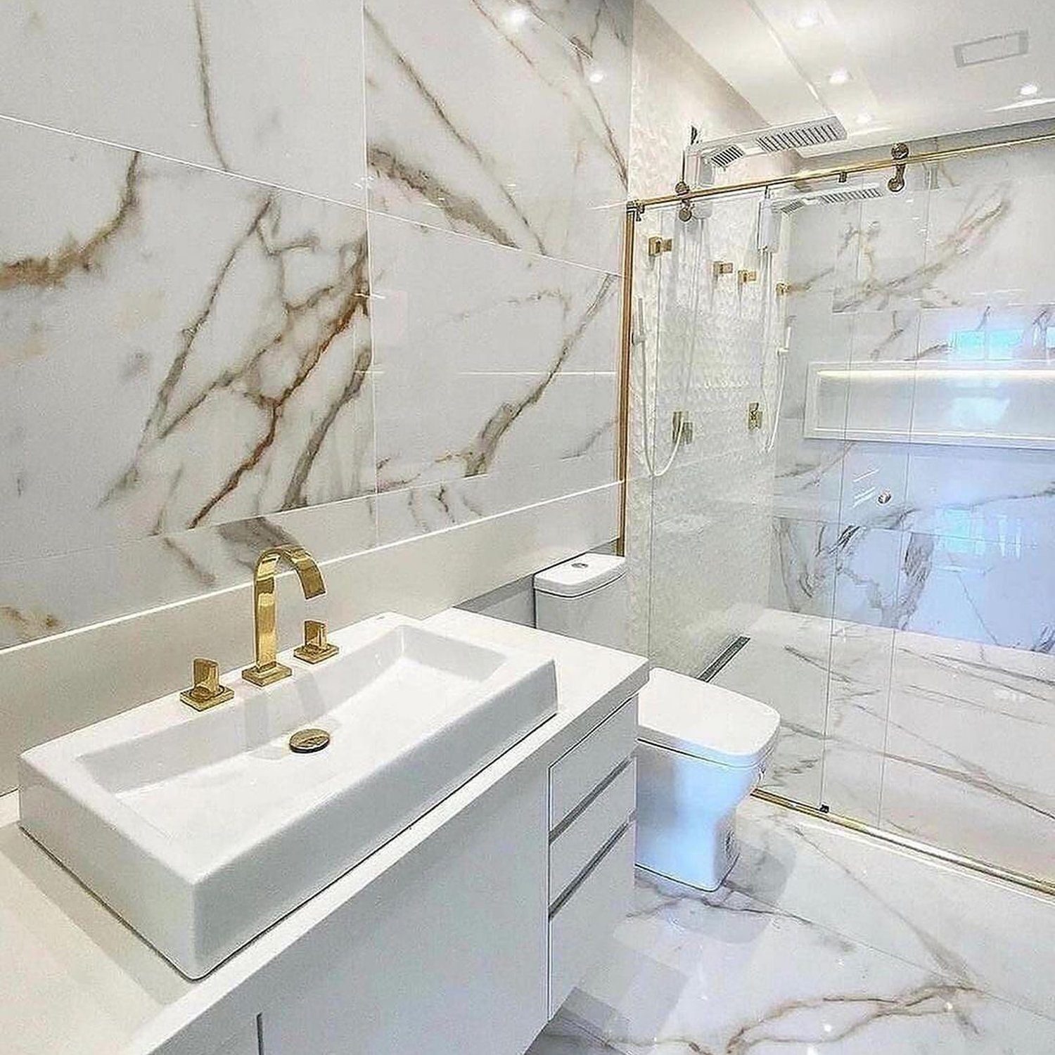 A pristine white marble bathroom with sleek fixtures