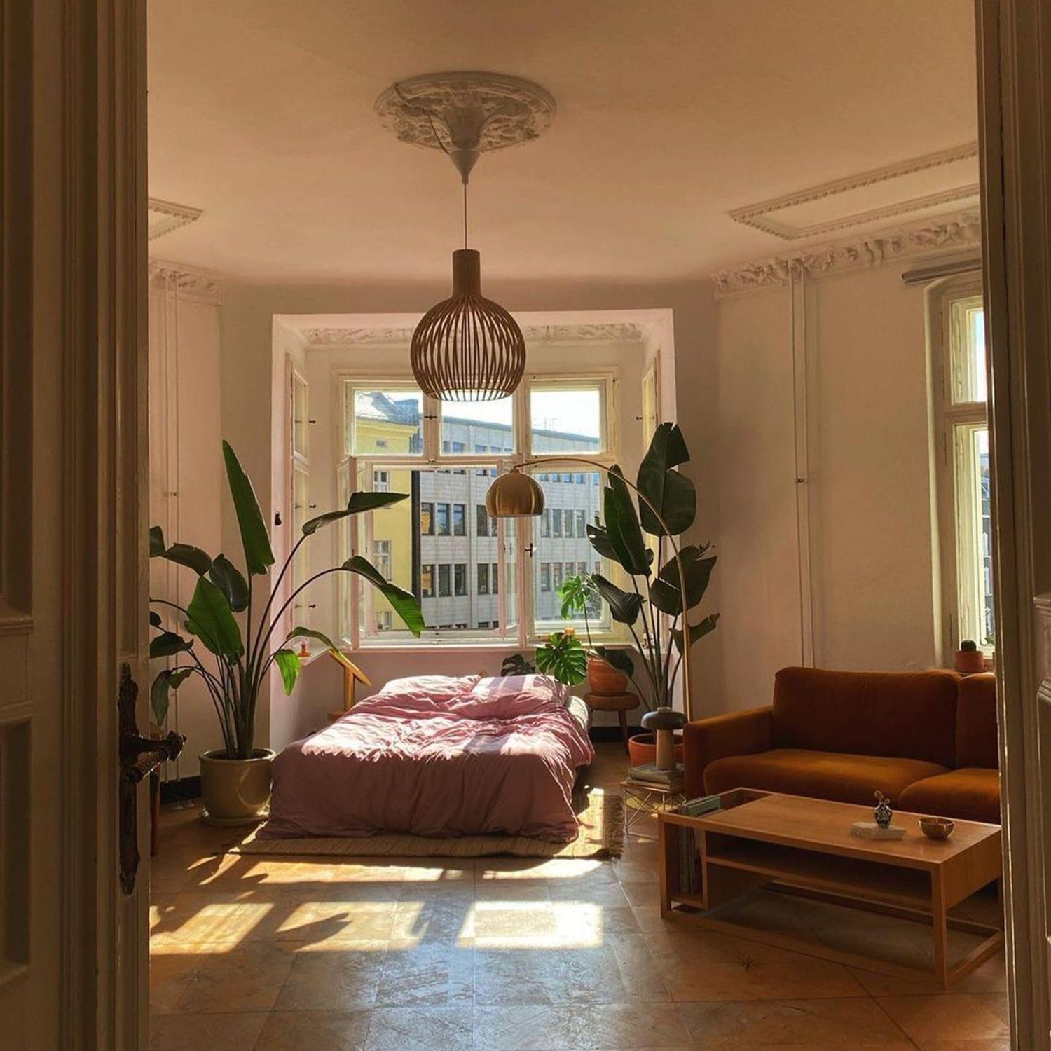 A warm and inviting bedroom with afternoon sunlight