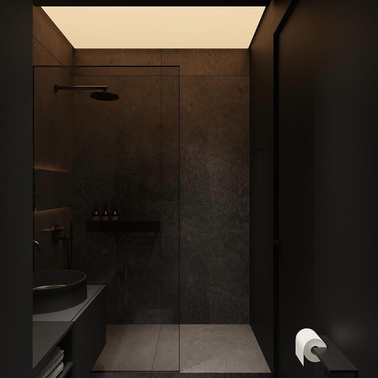 Elegant and minimalist dark bathroom with uniform grey tiles, featuring a streamlined metal and stone basin, seamless glass shower, and recessed shelving