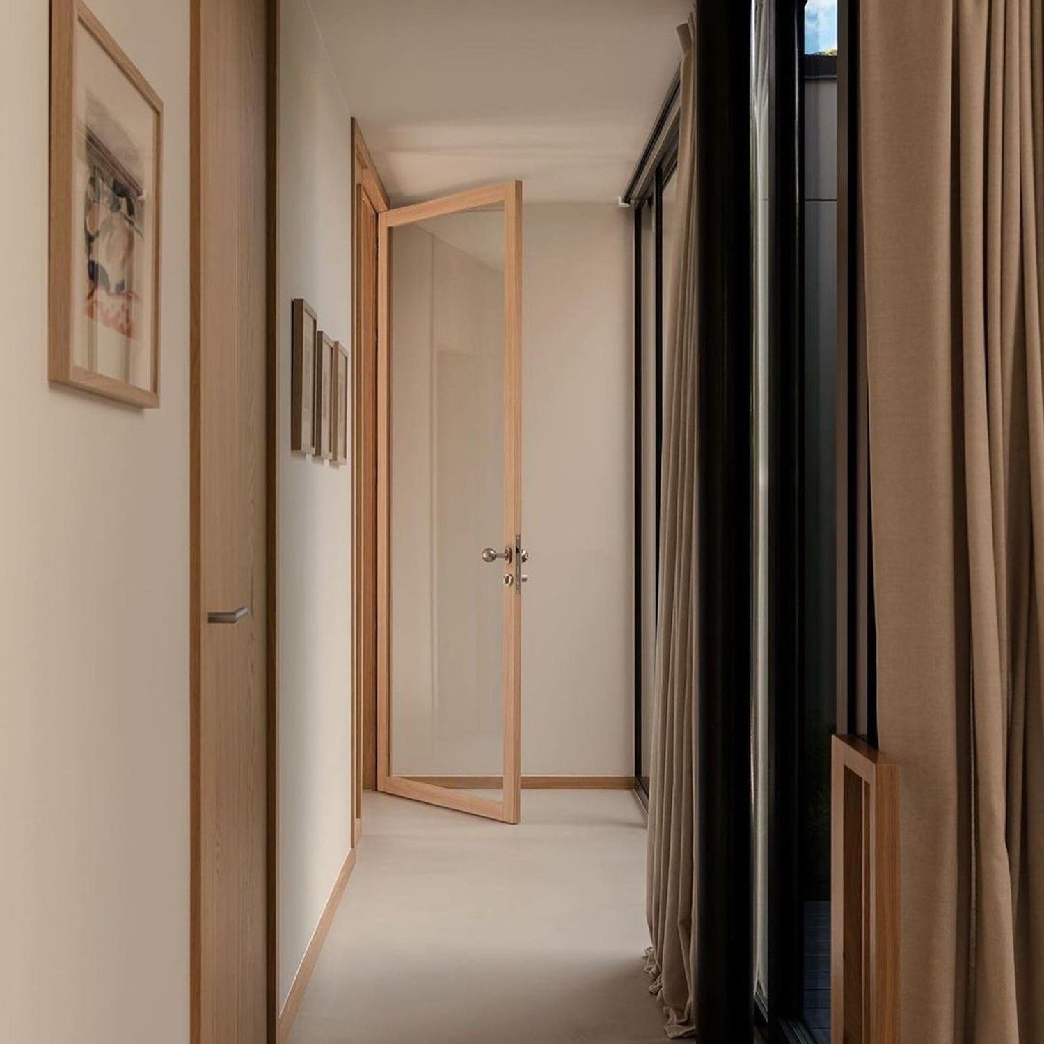 A hallway designed with minimalistic elegance, combining warm wood tones and soft neutral hues.