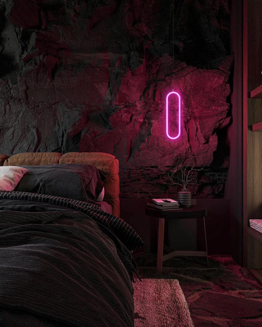 A bold, atmospheric bedroom design featuring rugged rock textures and a glowing neon light