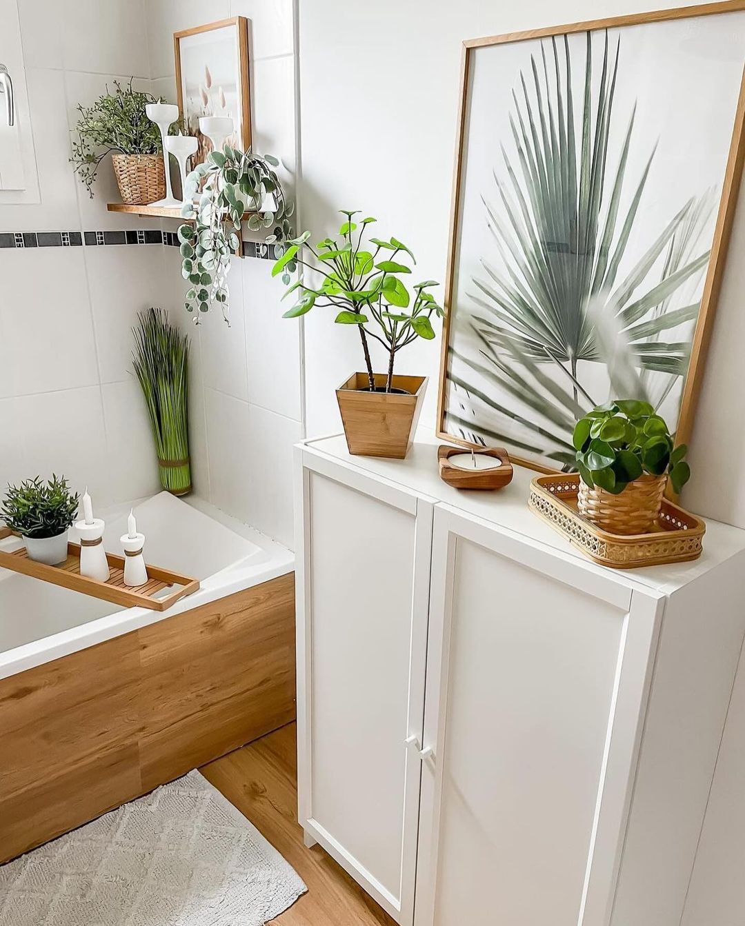 A modern bathroom with natural wood accents and vibrant plant decor