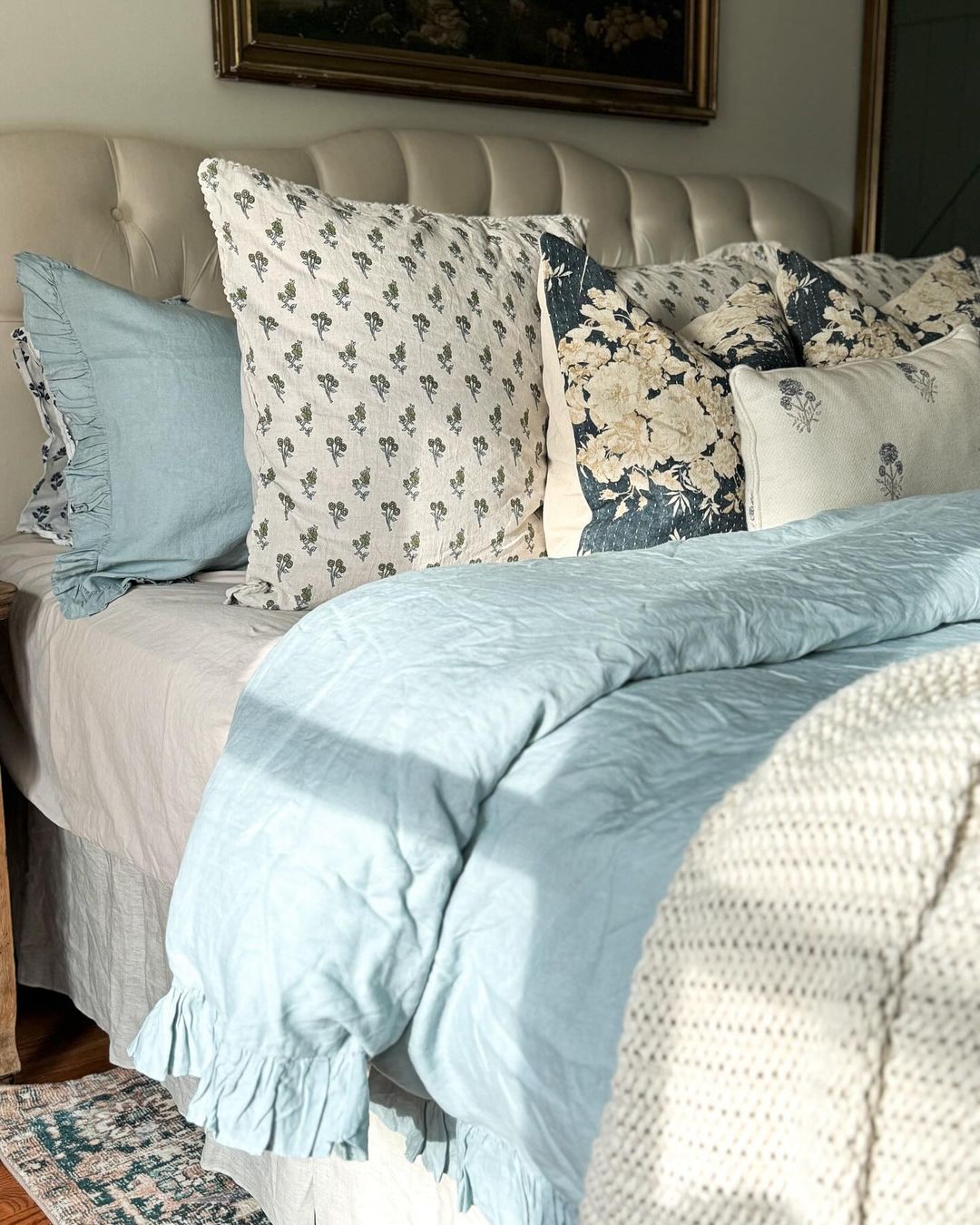 A cozy and inviting bedroom with an array of decorative pillows