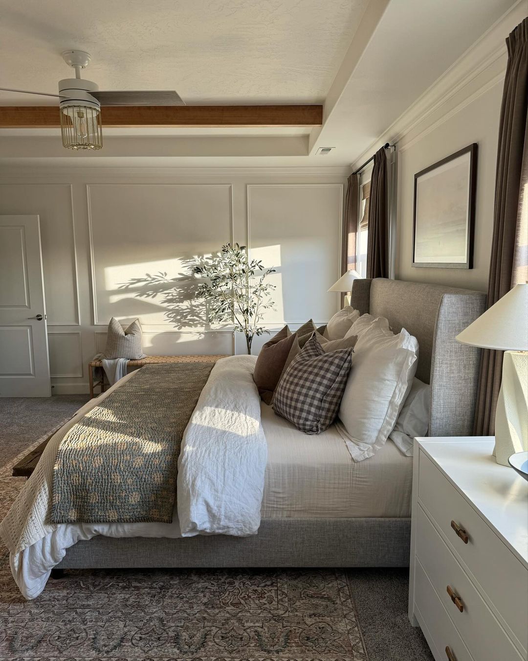 A serene and well-appointed bedroom with morning sunlight casting soft shadows