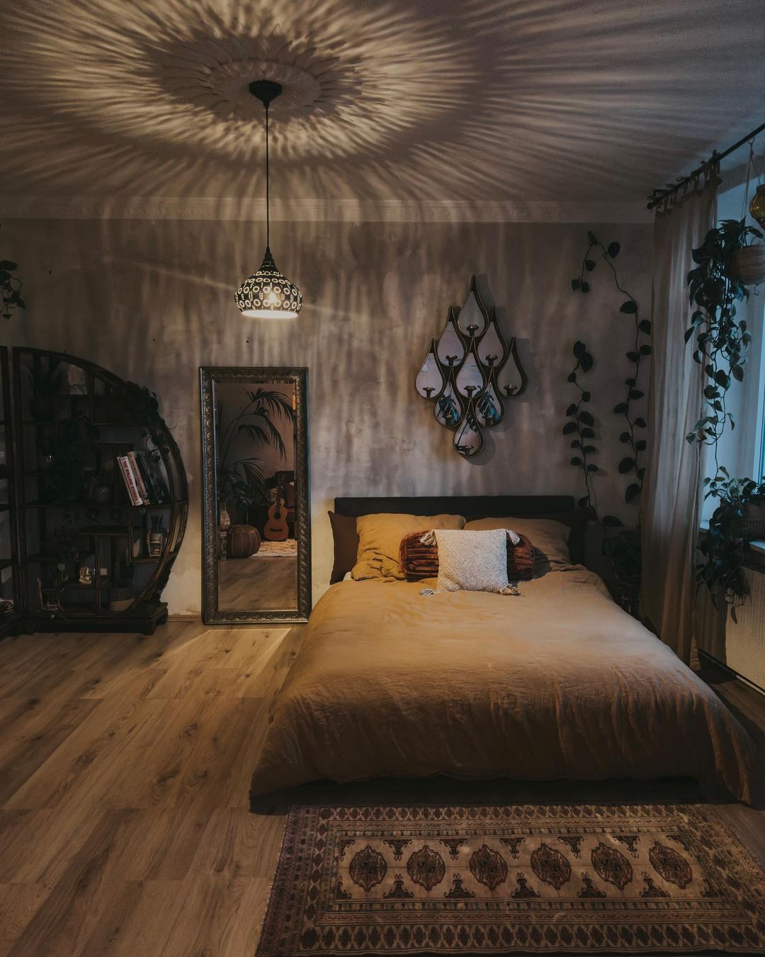 A cozy bedroom setting featuring warm lighting and eclectic decor