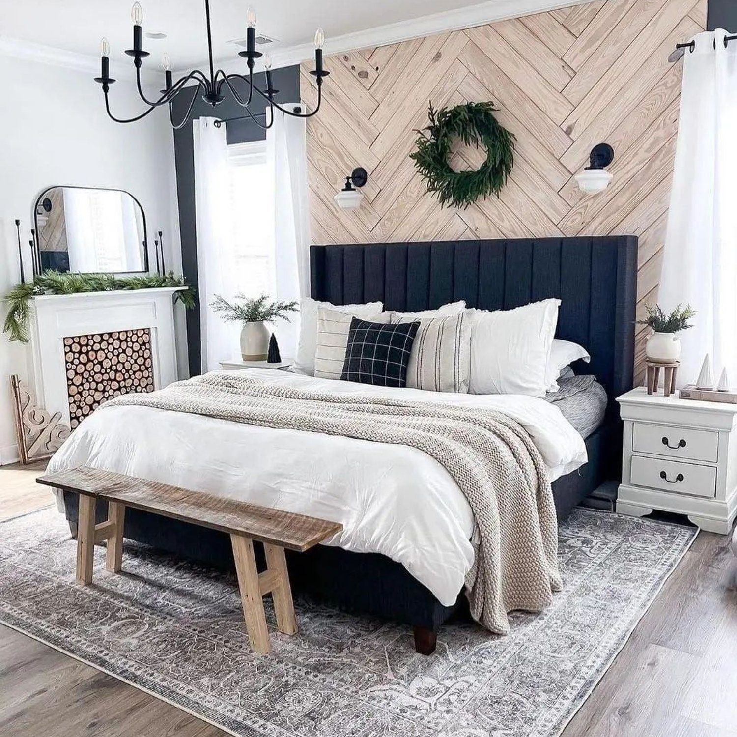 A chic and modern bedroom with a distinctive herringbone accent wall