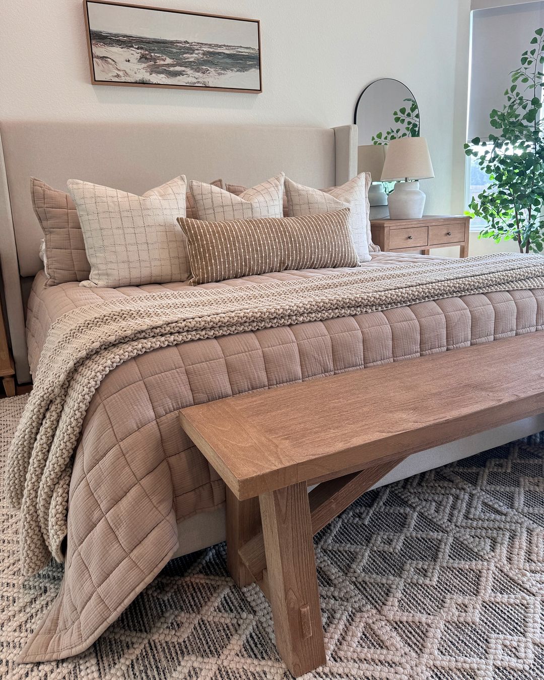 A cozy and well-coordinated bedroom with a neutral color palette