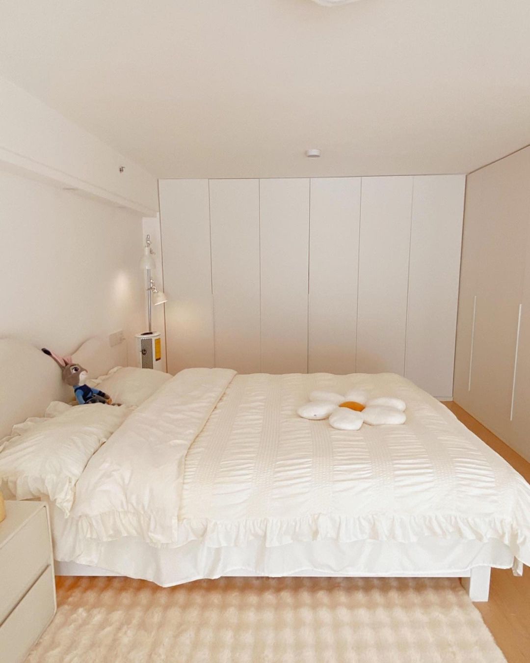 A neatly arranged bedroom with a plush bedspread