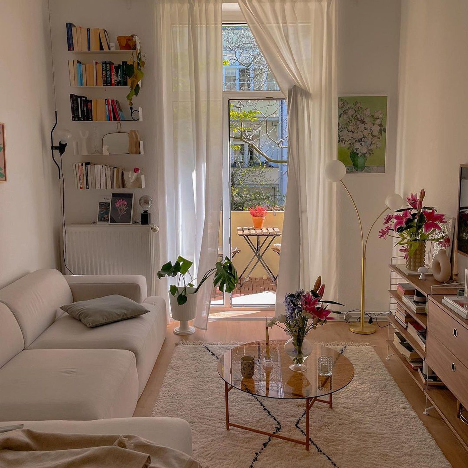 Cozy urban living room with sunlight filtering through balcony doors