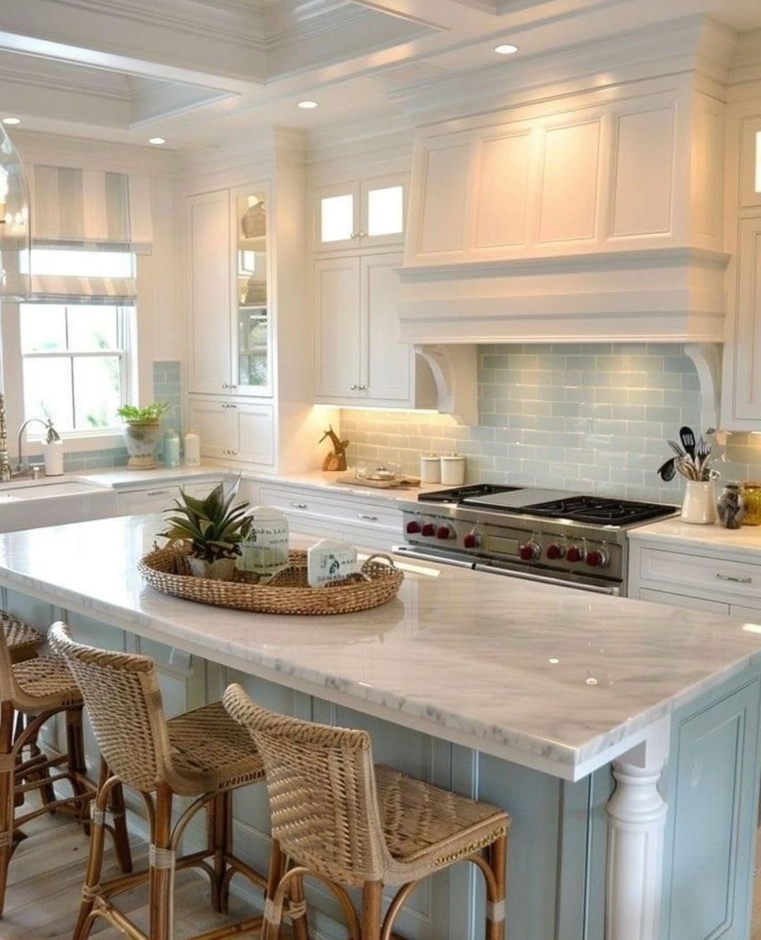 A bright and inviting kitchen featuring white cabinetry, light blue tile backsplash, and a central island with wicker bar stools.