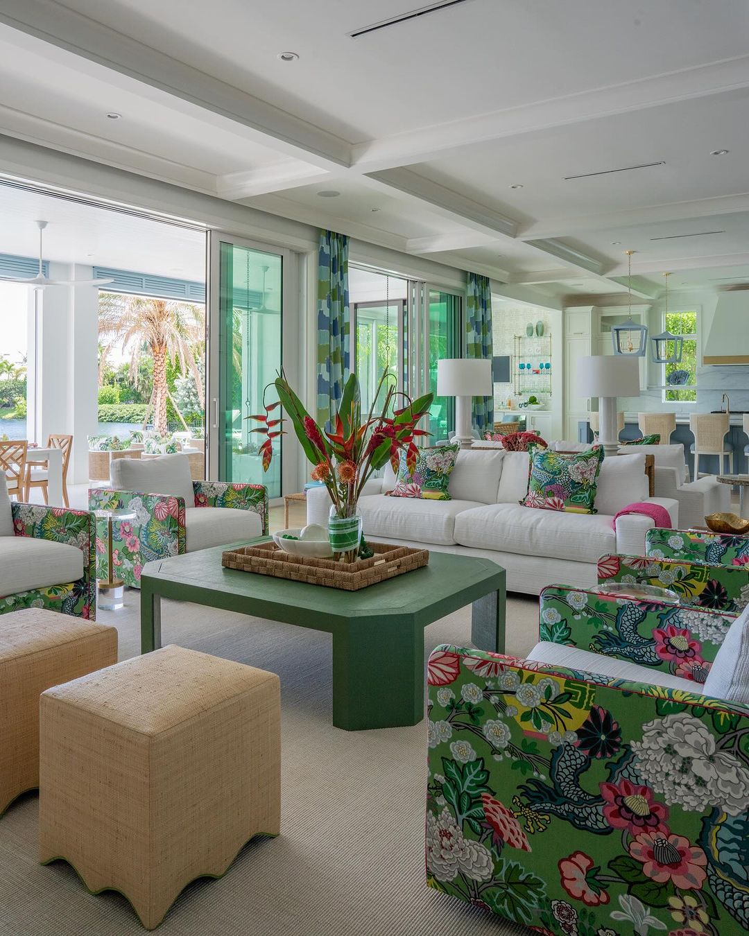 A modern living room with vibrant floral patterns and lush green accents