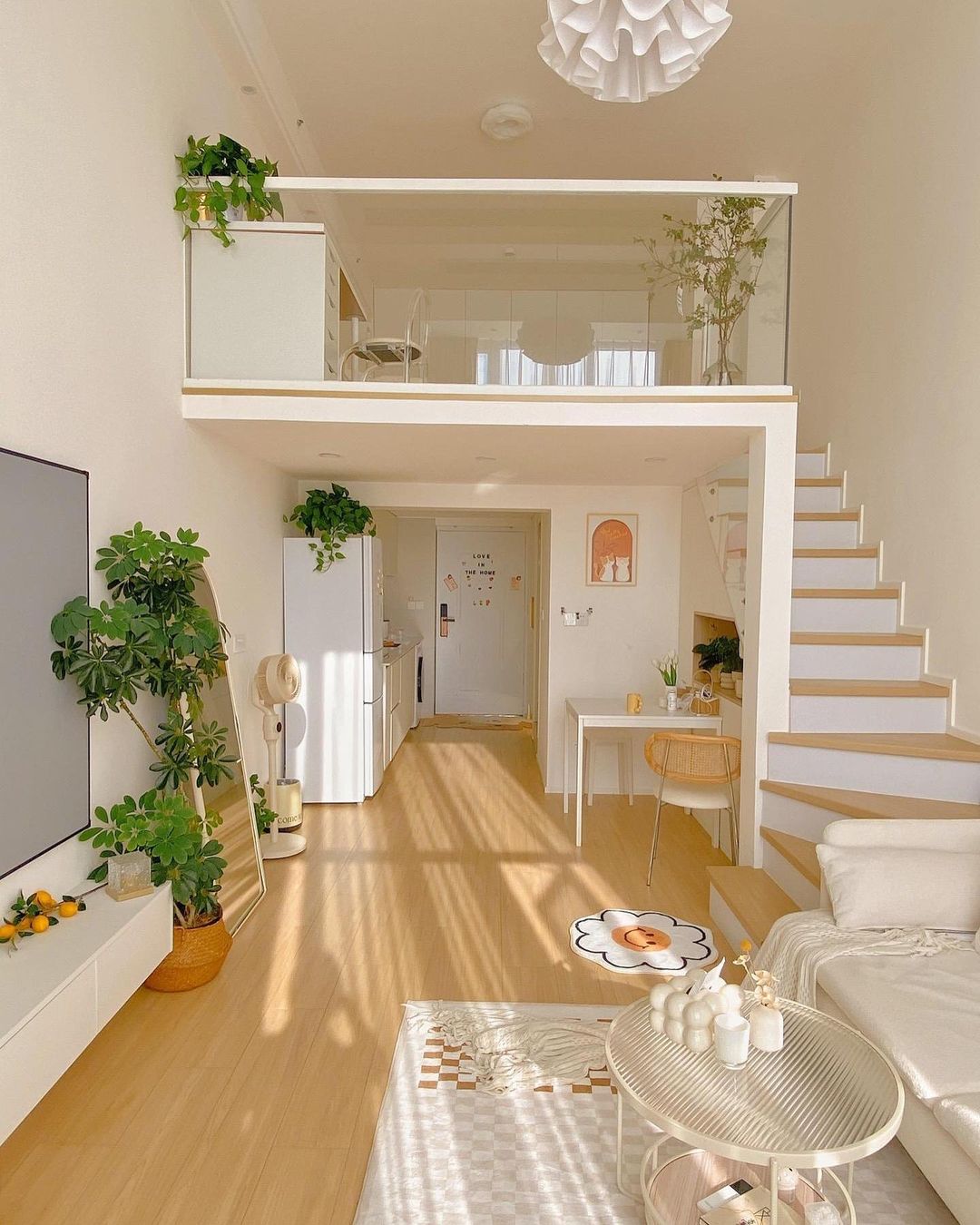 Bright and airy loft apartment with white decor and indoor plants