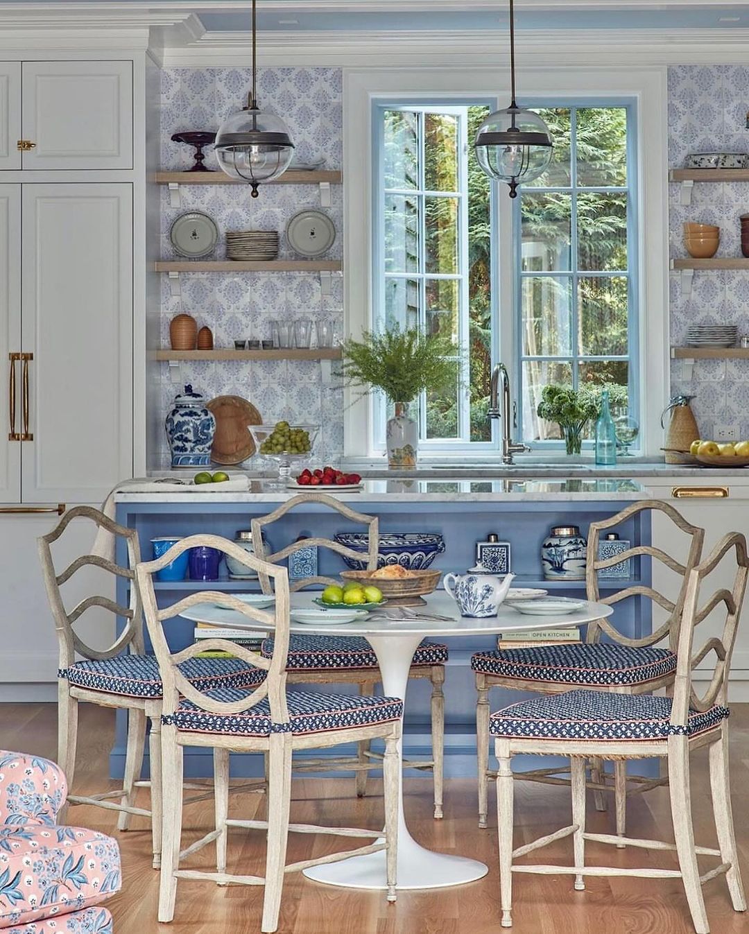 A charming and inviting kitchen space featuring open shelving and classic blue and white decor