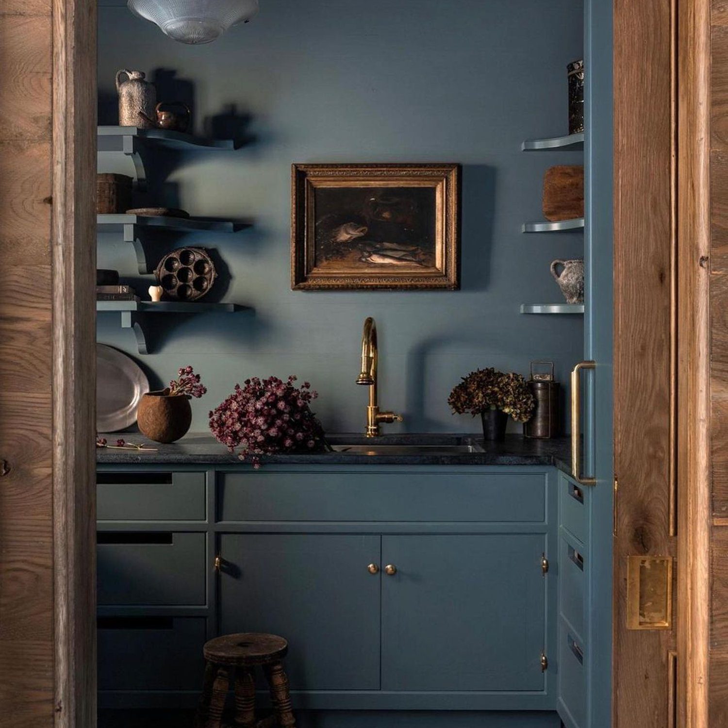 Elegant blue kitchenette with brass accents