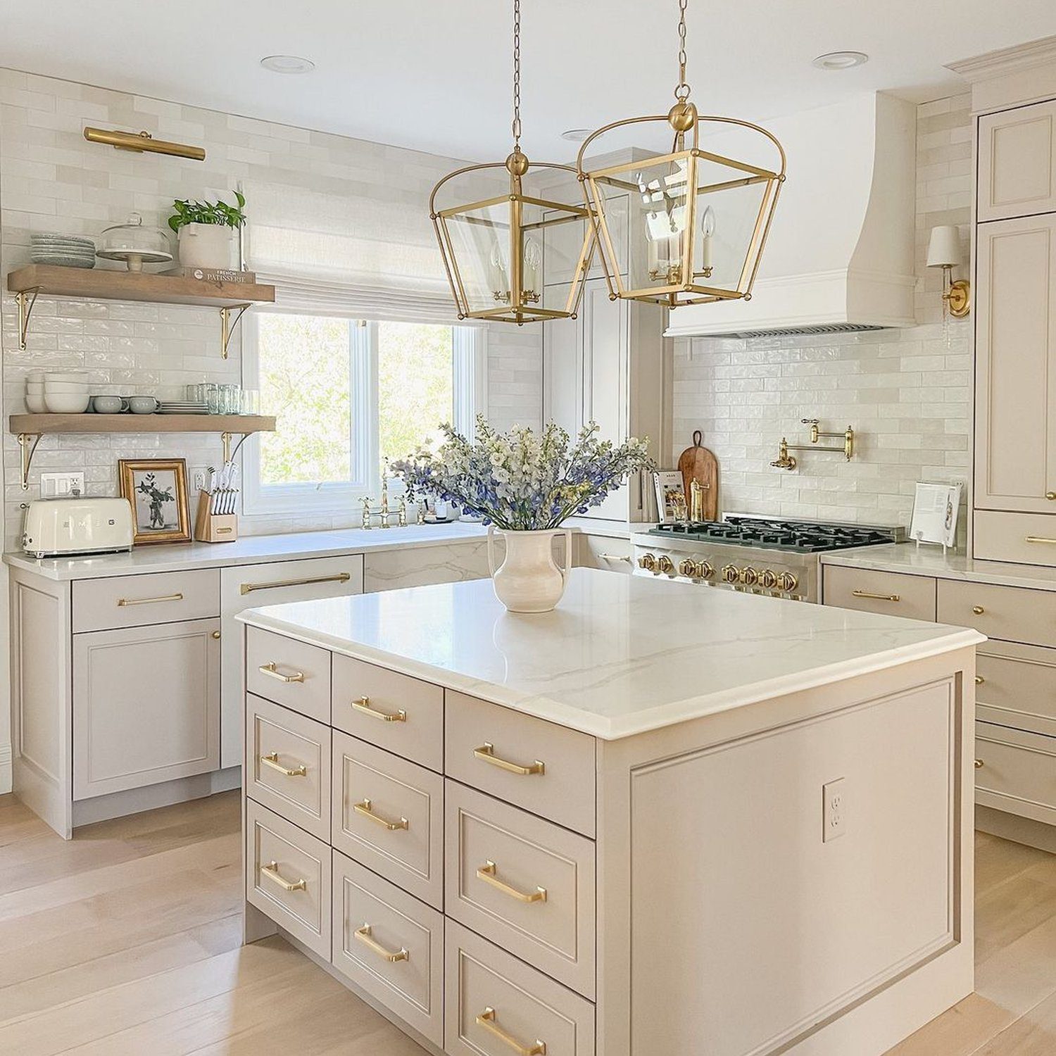 Elegant white kitchen featuring gold accents