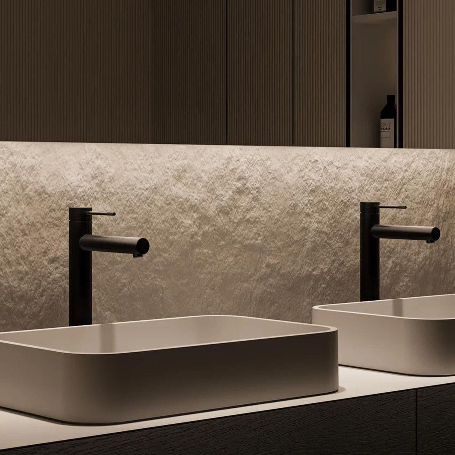 A modern minimalist bathroom design featuring sleek rectangular basin sinks and matte black faucets.