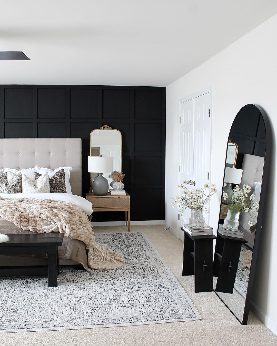 A chic and minimalistic bedroom featuring bold contrasts and textures