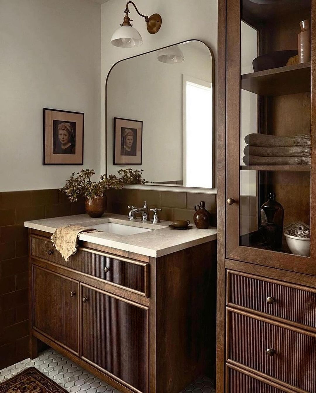 A stylishly designed bathroom showcasing a blend of dark green subway tiles and wooden texture