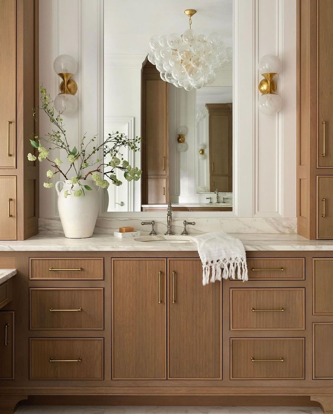 A tastefully designed bathroom featuring wood cabinetry