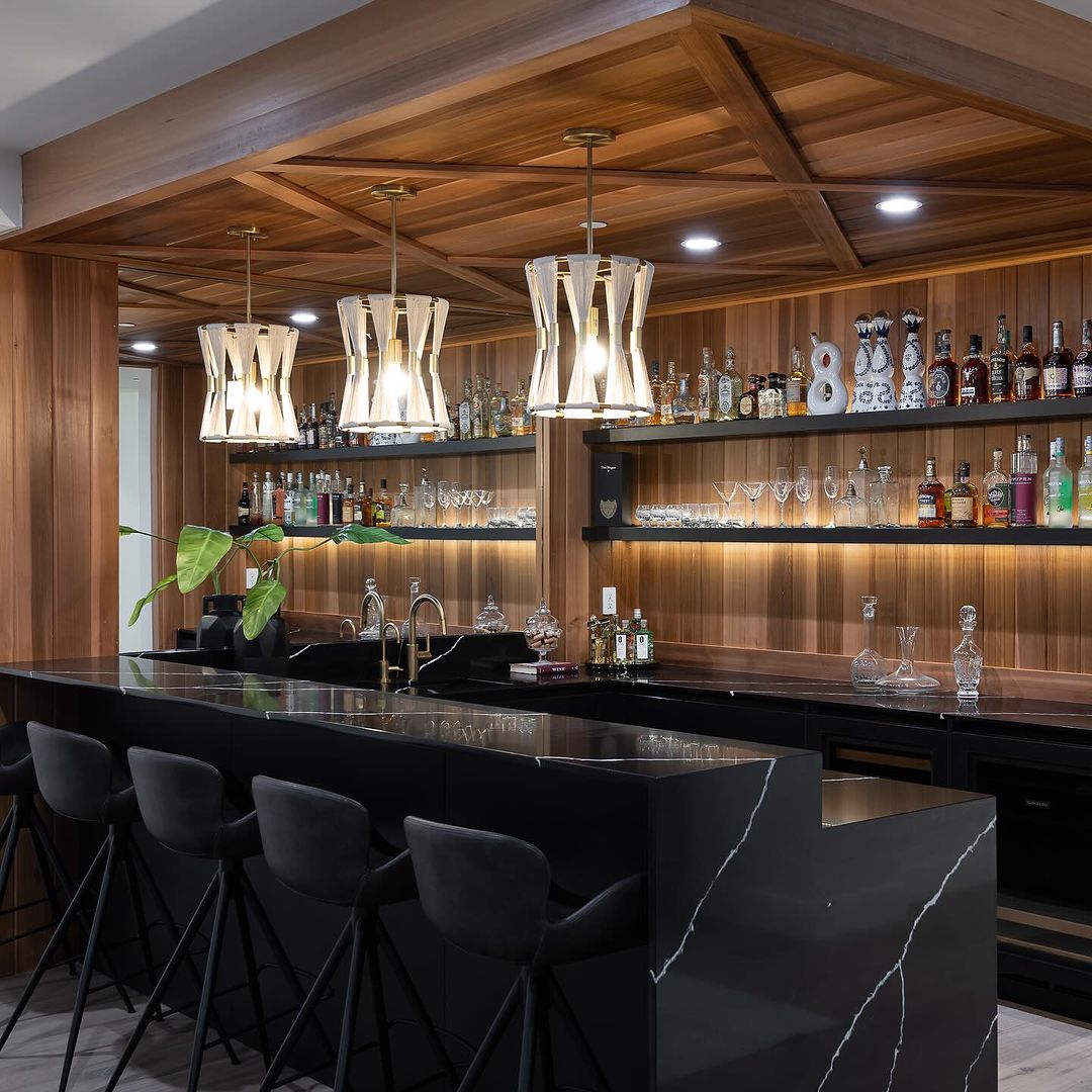 Stylish home bar with warm wooden accents and modern black counters