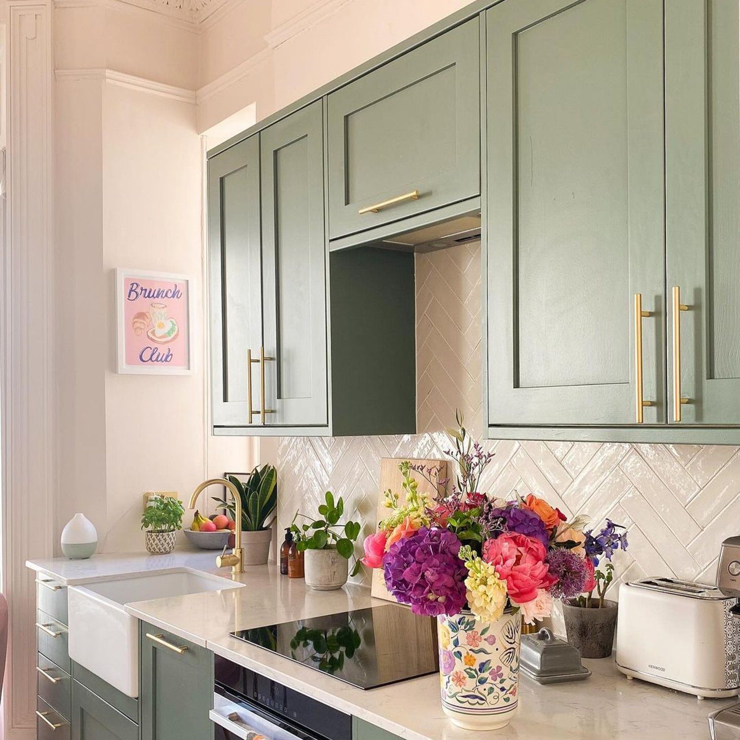 Elegant kitchen design with green cabinetry