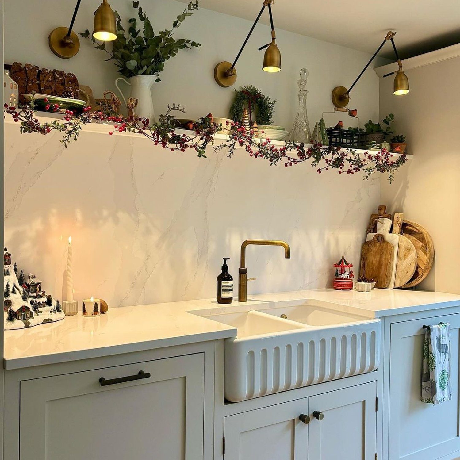 Elegantly designed kitchen featuring marble backsplash and gold accents