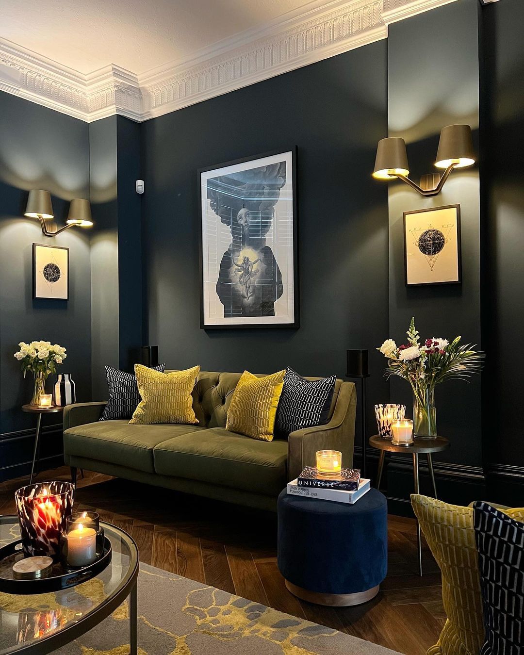 A chic living room featuring deep green sofas accented with yellow pillows