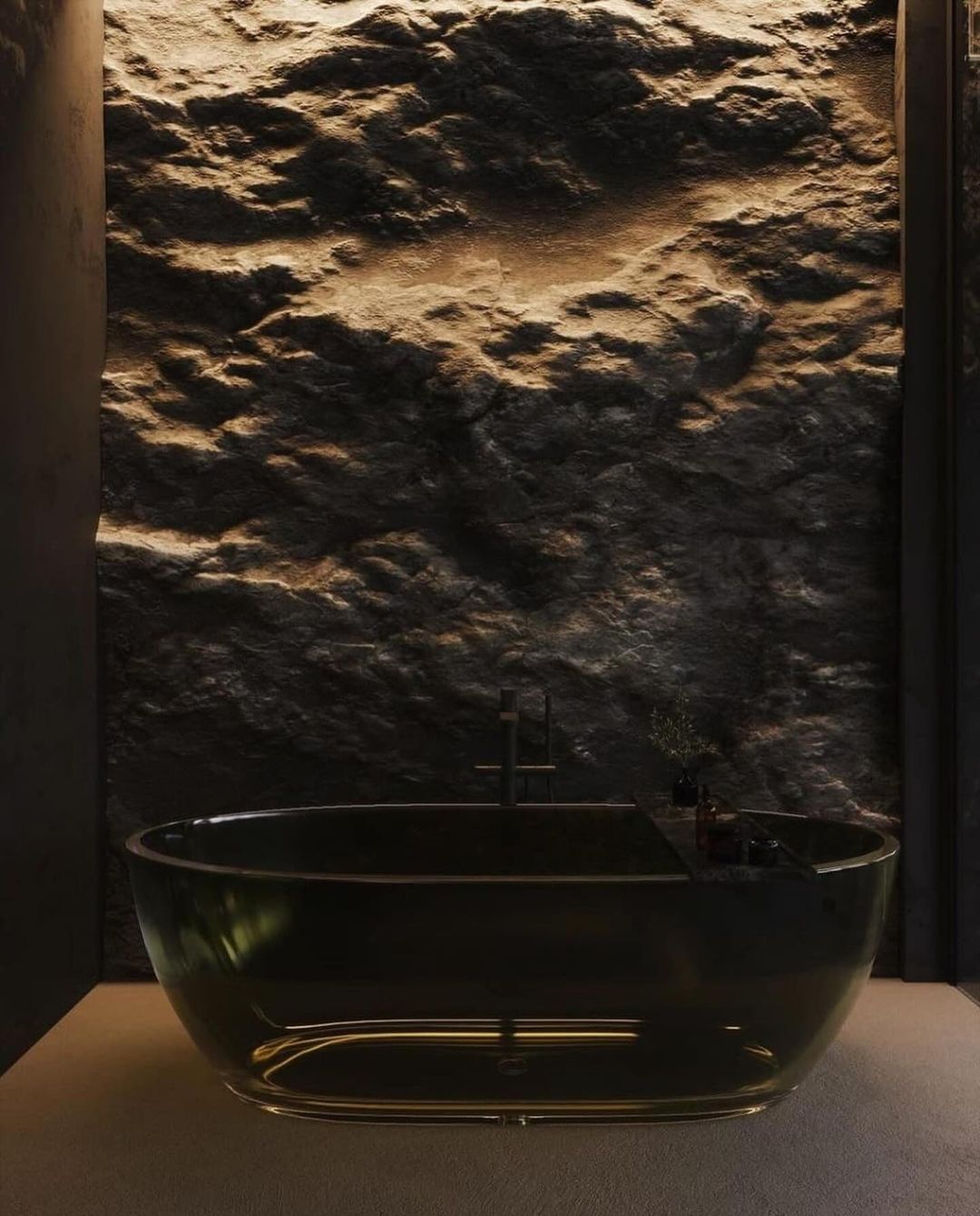 A chic modern bathroom featuring a textured stone wall and a sleek black freestanding bathtub